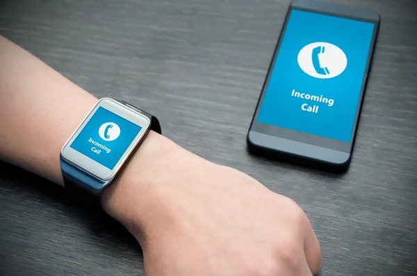 スマート フォーに接続されているスマートな腕時計で着信のお知らせ — ストック写真