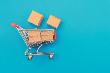 Karton kutularla alışveriş arabası. İnternet alışveriş kavramı