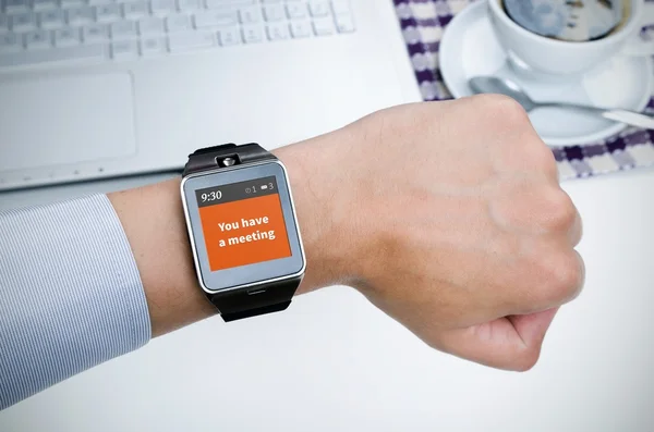 Businessman working with smart watch in restaurant — Stock Photo, Image