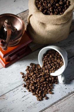 Bir fincan kahve tahıl sızıntısı. Kavrulmuş fasulye ve MIL jüt çanta