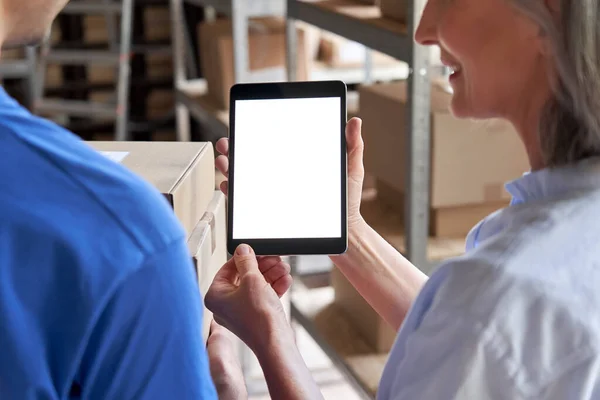 Inventory warehouse manager using digital tablet white screen talk to courier.