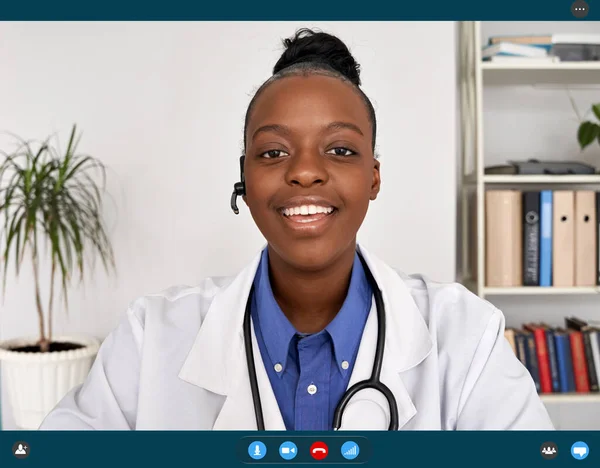 African female doctor talking to web camera, telemedicine video call.