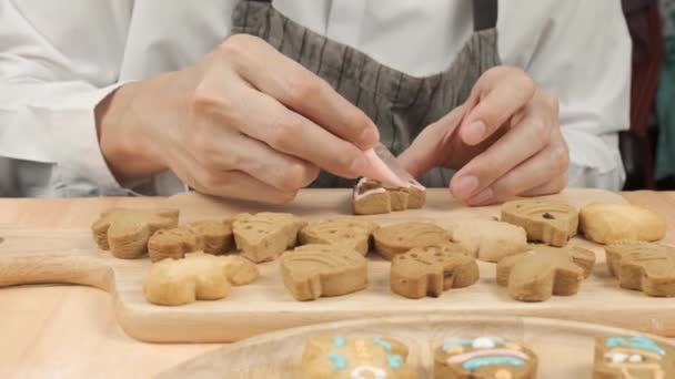 Close Chef Writing Sugar Cream Christmas Homemade Gingerbread Tree Cookies — Stock Video