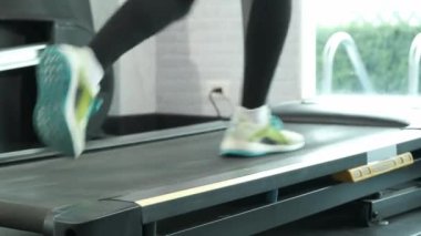 Close up Foot Fitness Asian woman walk to run warm up on running track machine, marathon races training at fitness gym