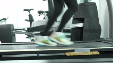 Fitness Asian woman stop run and stand on running track machine for rest, marathon races training at fitness gym