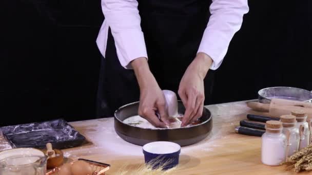 年轻的亚洲厨师在搅拌面团做面包之前 用测量杯从碗中的四个面包中取出鸡蛋 清除多余的配料 — 图库视频影像