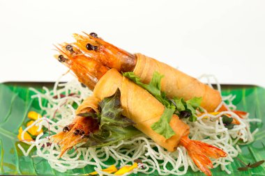 Beyaz arka planda aperatif olarak kızarmış karidesli dürüm ve çıtır erişteyi kapat.