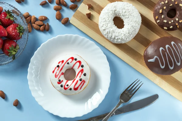 Tasty donuts with fruit and nuts — Stock Photo, Image