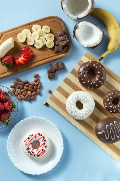 Tasty donuts with fruit and nuts — Stock Photo, Image