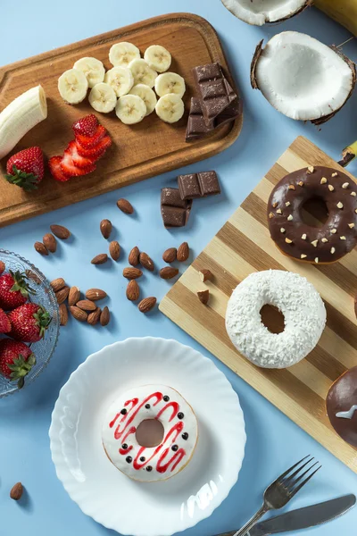 Tasty donuts with fruit and nuts — Stock Photo, Image