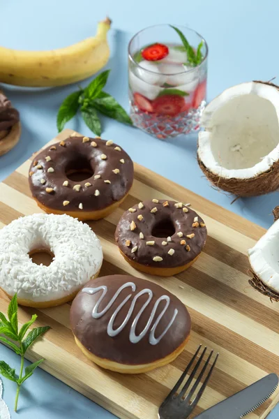 Tasty donuts with fruit and nuts on the table — Stock Photo, Image