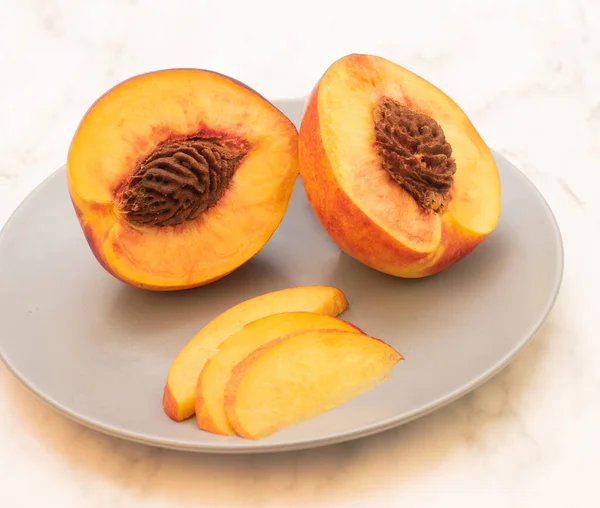 Peaches lying on a plate — Stock Photo, Image