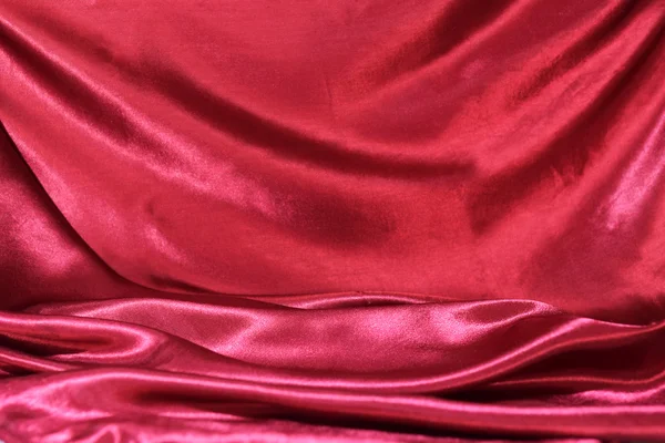 Undulating folds of the fabric of dark red silk — Stock Photo, Image