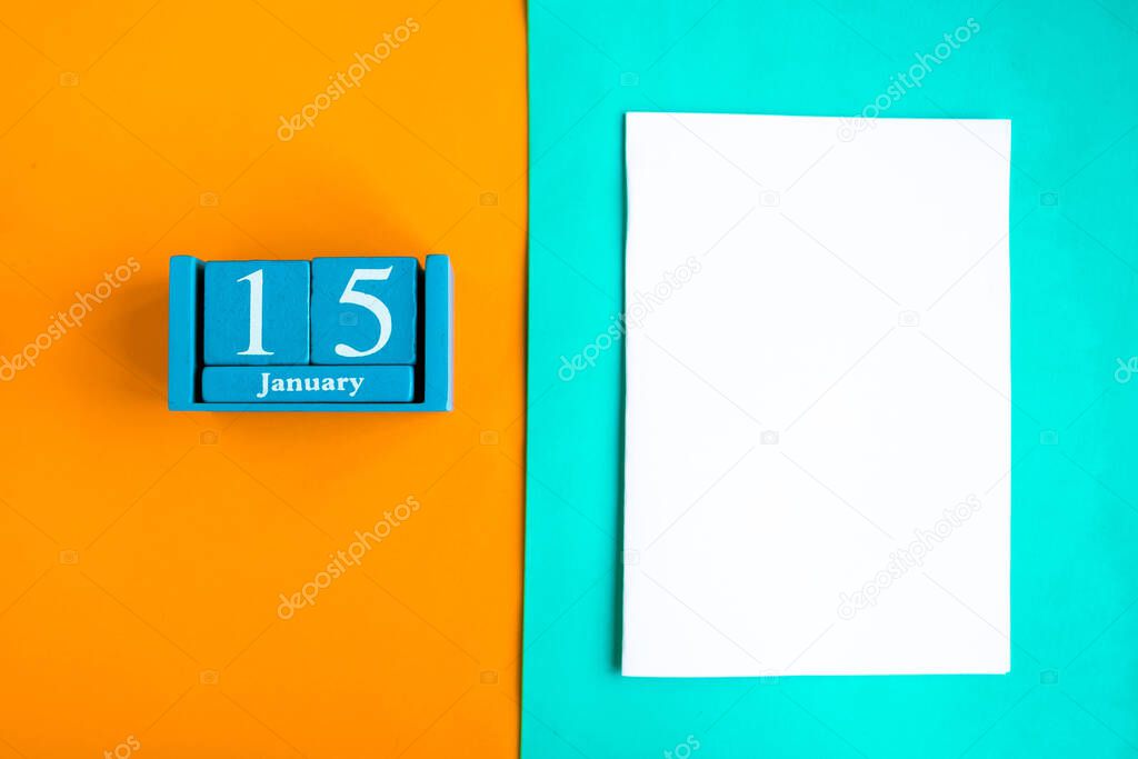 January 15. Blue cube calendar with month and date and white mockup blank on color background.