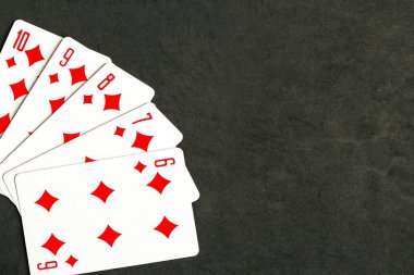 Poker straight flush playing card, top view, black background