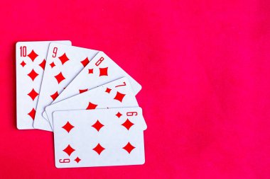 Poker straight flush playing card, top view, red background