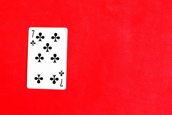 Seven Clubs Playing Card Red Background Top View — Stockfoto
