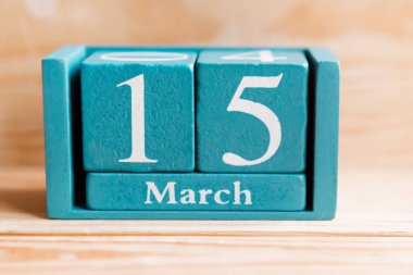 15 Mart. Ahşap zemin üzerinde ay ve tarih olan mavi küp takvimi.