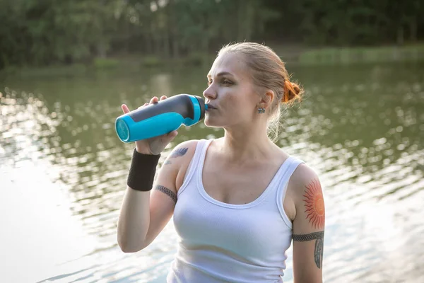 Runner wearing medical mask, Coronavirus pandemic Covid-19. Sport, Active life in quarantine surgical sterilizing face mask protection. Outdoor run on athletics track in Corona Outbreak