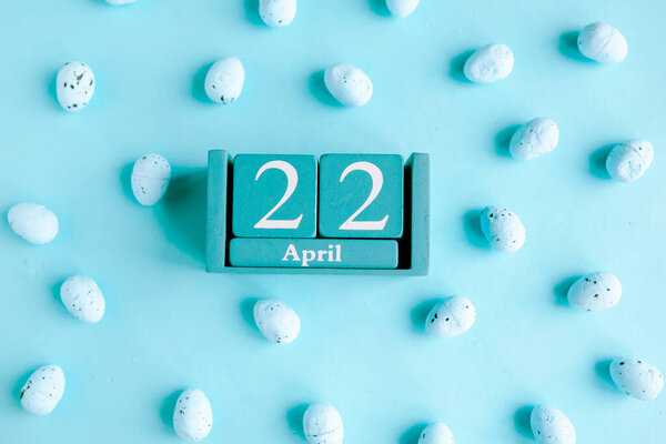 April 22. Blue cube calendar with month and date on blue background.