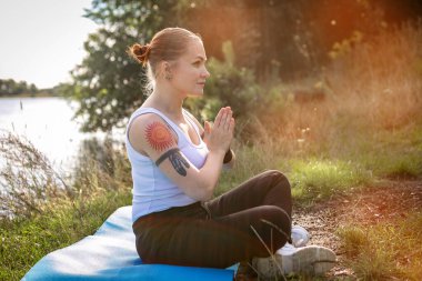 Girl do exercise in the forest during the coronavirus outbreak, outdoor sport activity concept