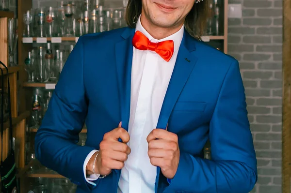 man in blue suit with red bow tie. Wedding concept