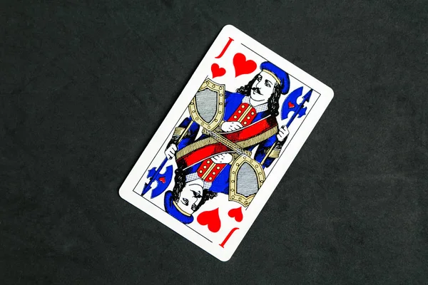 Joker of diamonds playing card, wooden background, copy space