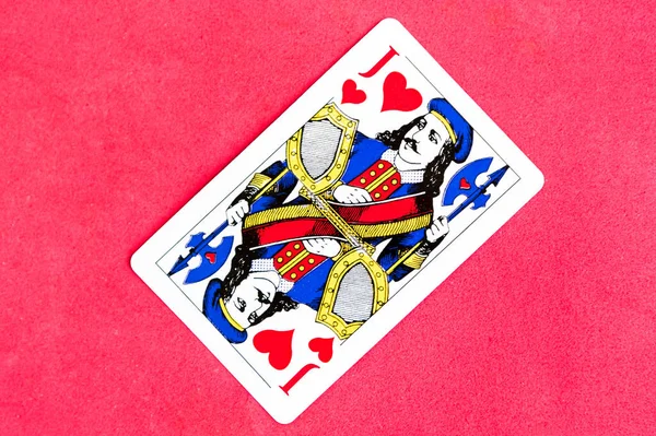 Joker of diamonds playing card, wooden background, copy space
