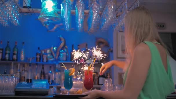 Kellnerin trägt Cocktails mit Wunderkerzen — Stockvideo