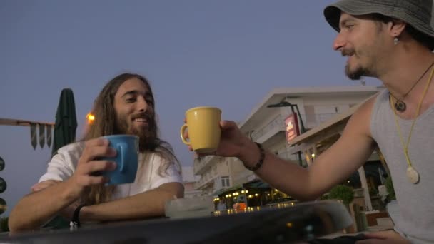 Oude vrienden rinkelende mokken op terras — Stockvideo