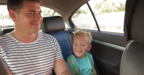 Cheerful father and son traveling by car — Stock Video