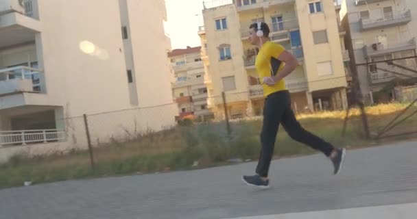 Hombre corriendo con música en la mañana — Vídeo de stock
