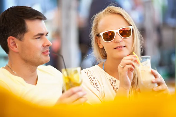 Jeune couple relaxant avec des boissons rafraîchissantes — Photo