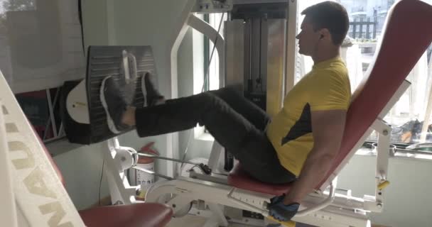 Man working out on leg press machine — Stock Video