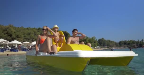 Family with child enjoying pedal boat ride — Stock Video