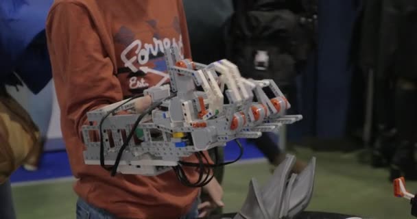 Electronic prosthetic arm on boys hand — Stock Video