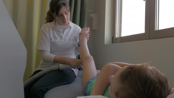 Boy taking physiotherapy treatment — Stock Video