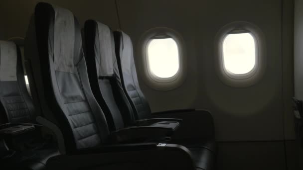 Seen interior decor of plane - black leather chairs and two portholes — Stock Video