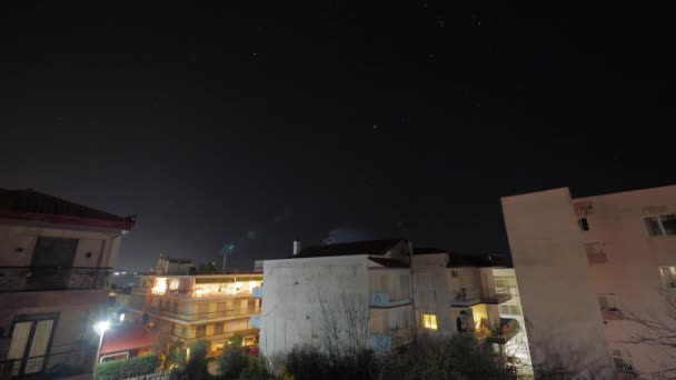Время неба со звездами над маленьким городом — стоковое видео