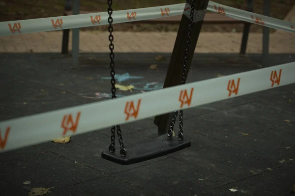 Swing in a kids playground cordoned off — Stock Photo, Image