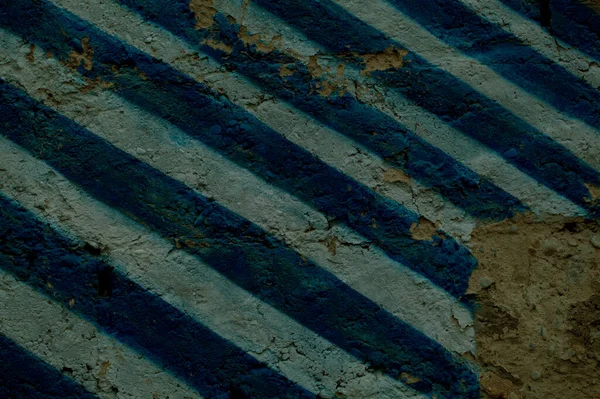 Diagonal blue and white stripes on an old wall — Stock Photo, Image