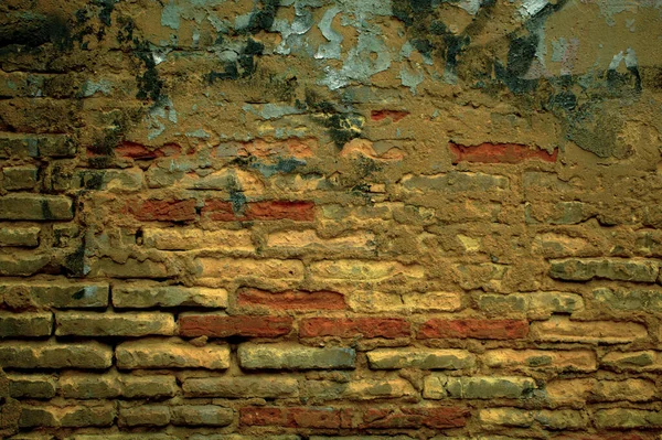 Old grunge weathered brick wall with graffiti