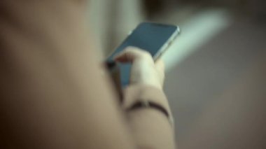 She must always be in touch. Using cellphone on the go