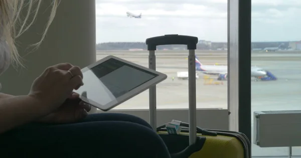 Mulher esperando o voo com tablet PC — Fotografia de Stock