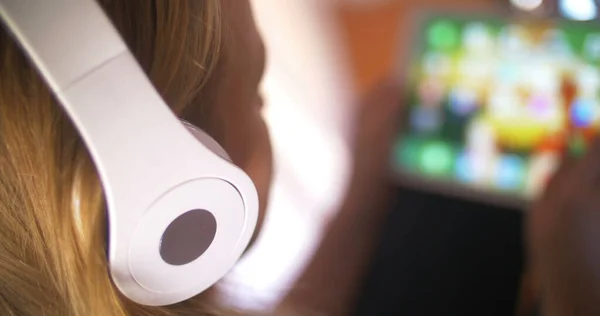 Woman in earphones working with touch pad — Stock Photo, Image