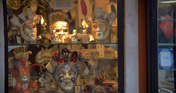 Venetian masks in glass show-window — Stock Photo, Image