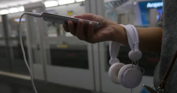 Woman using cellphone in subway — Stock Photo, Image