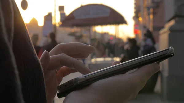 V Petrohradě, v Rusku na večerní ulici, dívka pracující na mobilním telefonu — Stock fotografie