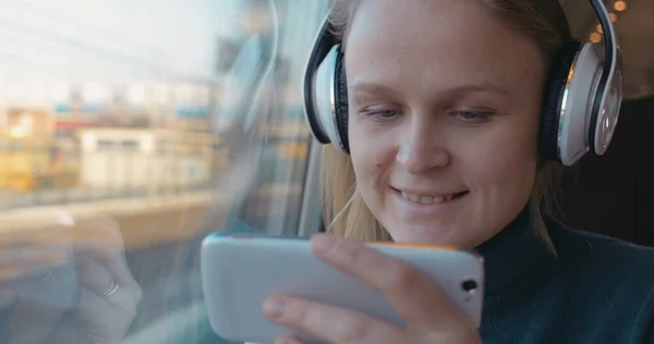 Entertainment with music and phone in the train — Stock Photo, Image