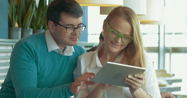 Young people with pad choosing something in Internet — Stock Photo, Image